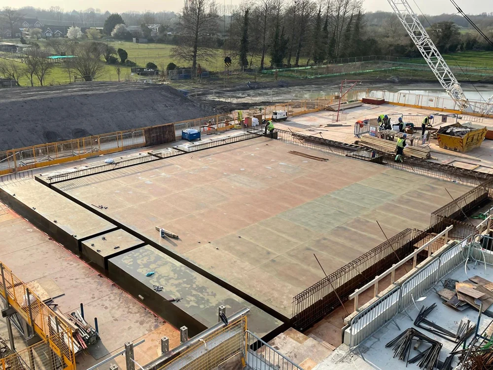 A highly commended Concrete Society project featuring 7,000sqm of exposed fine smooth concrete, including 15m span column-free floorplates and a striking circular event building.